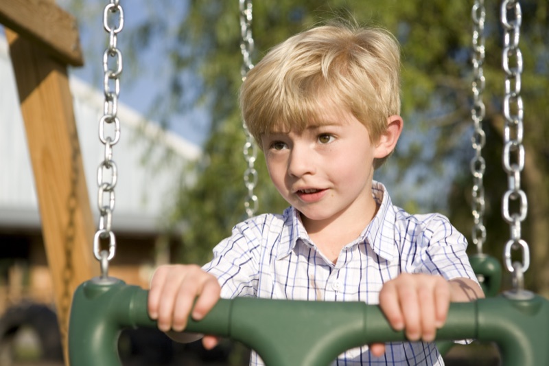 Galen as a boy on a swing